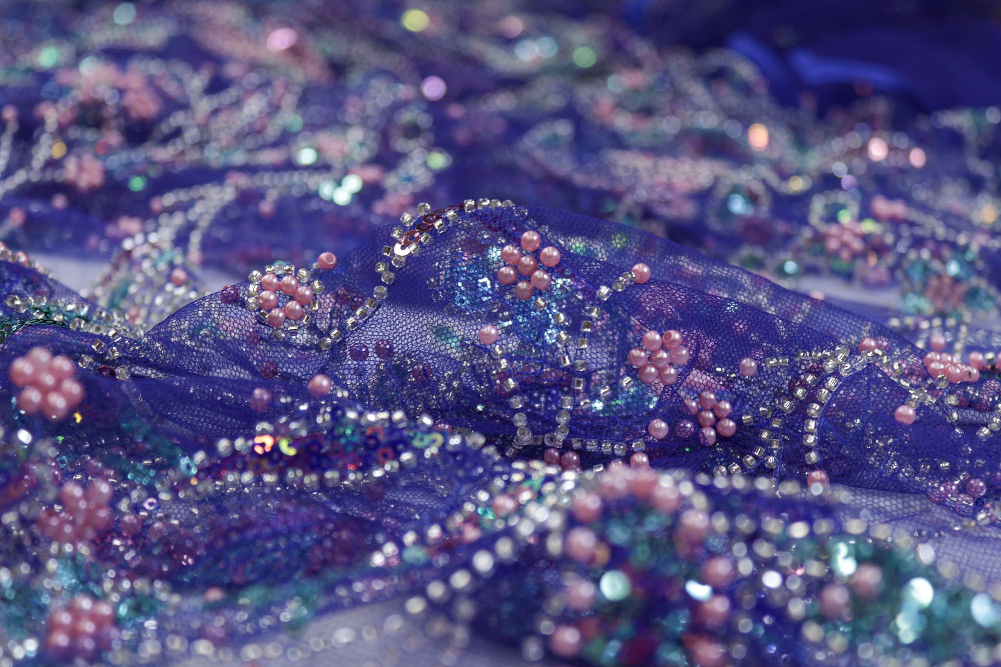 Blue net with multi color sequence, beads and pearls creating very intricate floral allover pattern